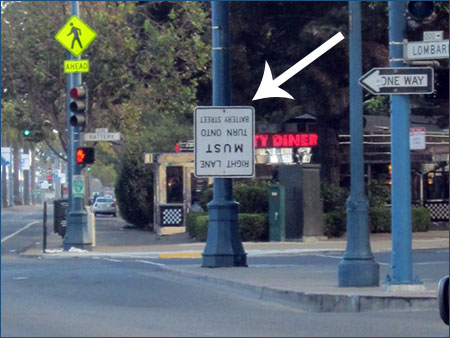 Upside-down road sign