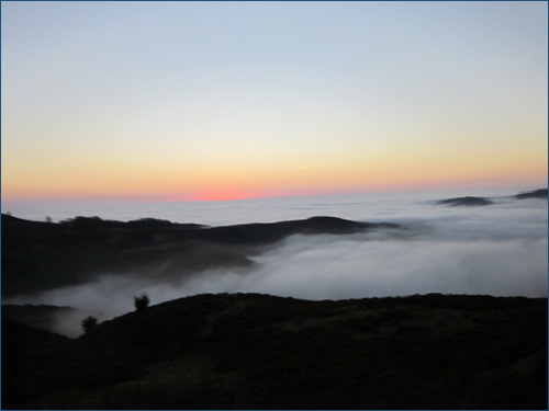 Sunset Over Fog and Mountains
